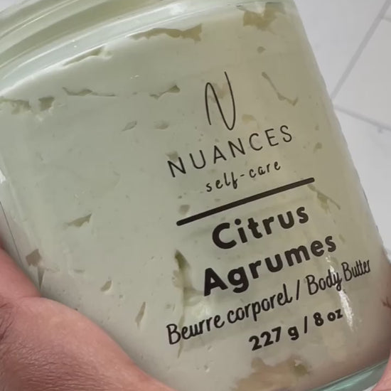 A video showing someone scooping the citrus body butter form the jar