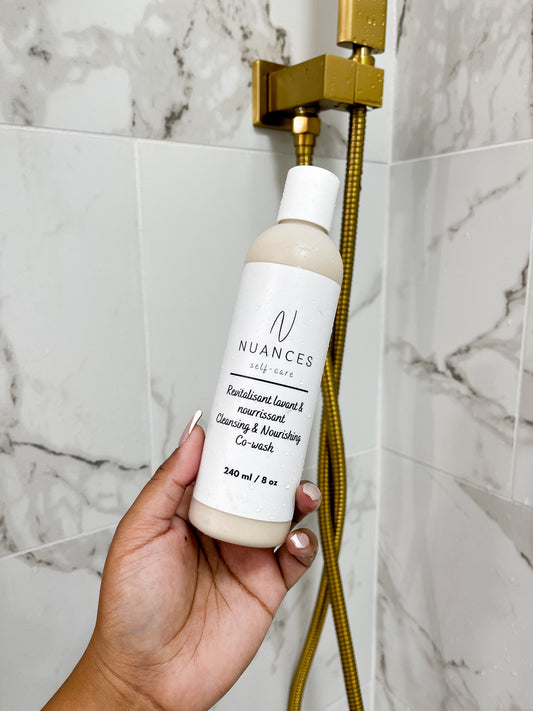 A bottle of the cleansing and nourishing co-wash shown in a shower.