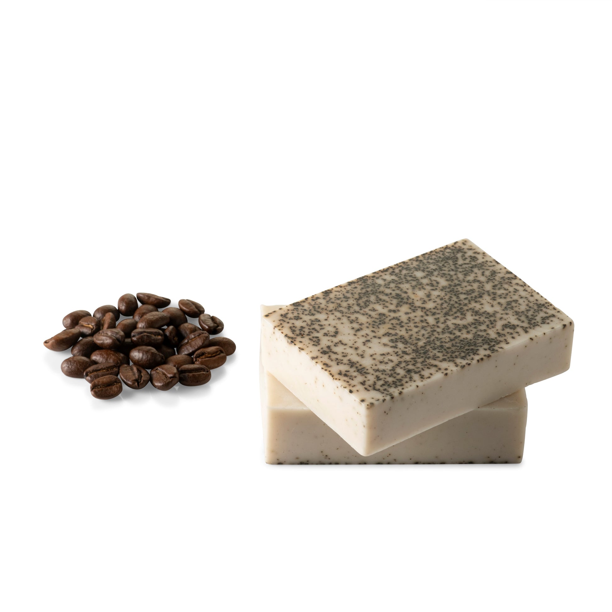 a picture of the coffee body soap next to coffee beans on a white background