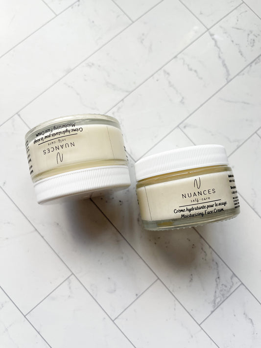 An image of two moisturizing face cream on  white marble background