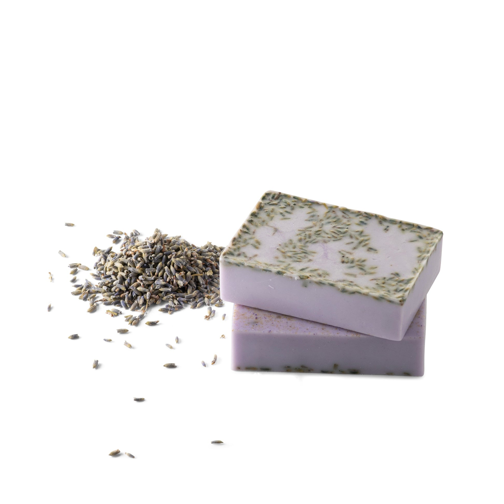 An image of the lavender body soap next to a handful of lavender grains on a white background